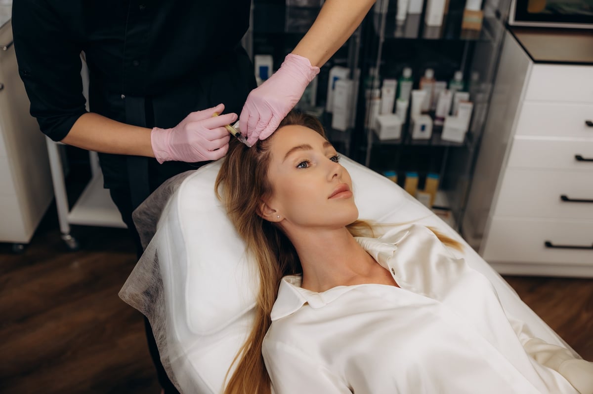 Female client undergoing mesotherapy injections for skin rejuvenation in a beauty clinic